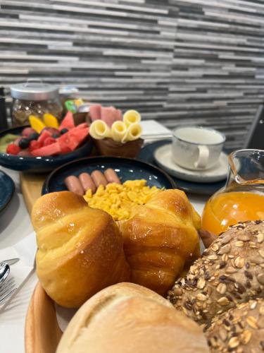 a table with a plate of food with eggs and bread at A Tendinha - Guest House in Peso da Régua
