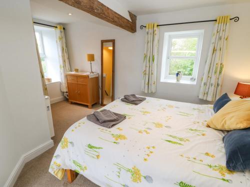a bedroom with a large bed and a window at Middlehope Cottage in Bishop Auckland