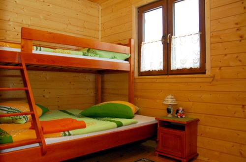 1 dormitorio con literas en una cabaña de madera en Domki Kazimierz, en Darłowo