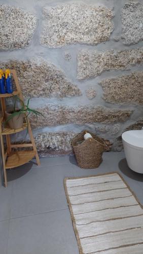 a room with two rugs on the floor and a wall at Quinta de Cerdeiró in Mões