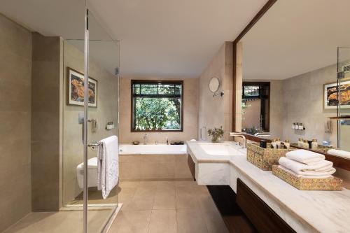 a bathroom with a tub and a sink at Taj Corbett Resort and Spa Uttarakhand in Rāmnagar