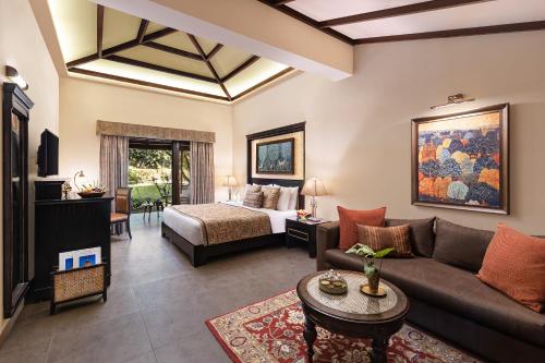 a living room with a couch and a bed at Taj Corbett Resort and Spa Uttarakhand in Rāmnagar