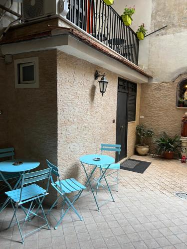 een patio met 2 stoelen, een tafel en een balkon bij Sciabbacco house in Napels