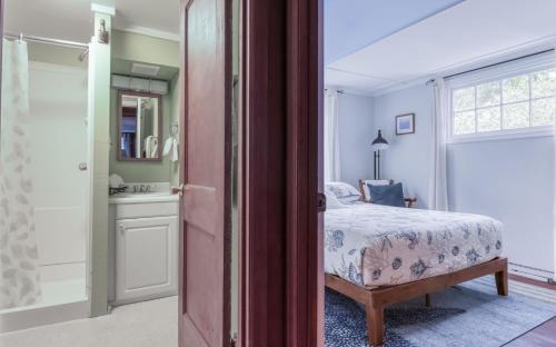 a bedroom with a bed and a bathroom with a window at Cute Manzanita Beach House MCA 749 - Meredith Lodging in Manzanita