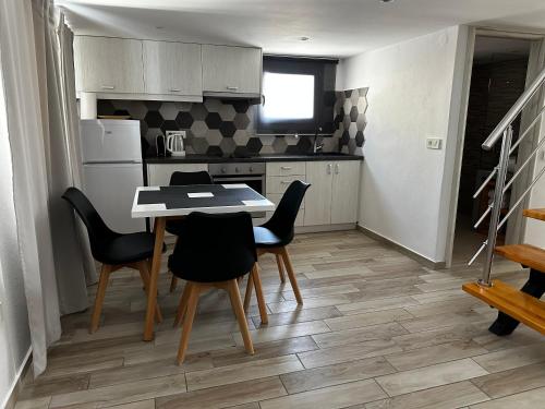 a kitchen with a table and chairs in a room at Selena Villa in Kamari