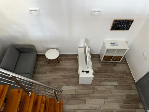 a room with a staircase with a refrigerator and a table at Selena Villa in Kamari