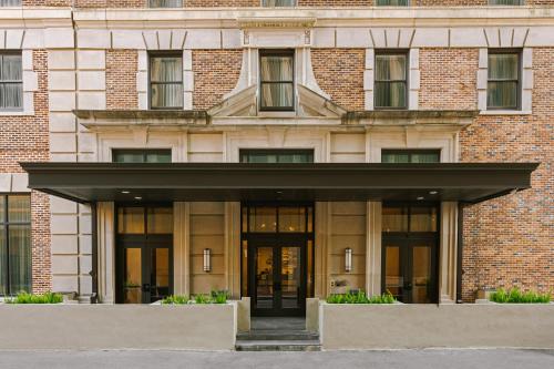 a large brick building with doors and windows at Sonder at 1500 Canal in New Orleans