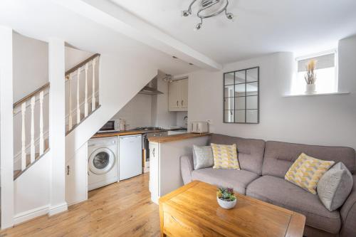 a living room with a couch and a table at Cobble Cottage in Richmond