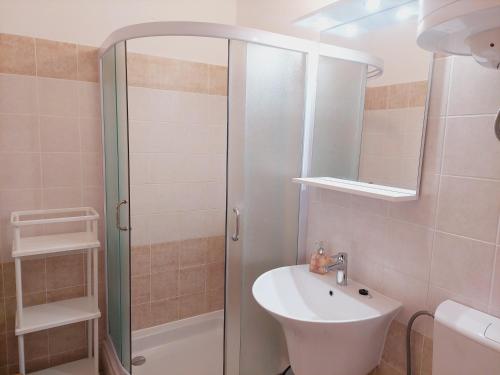 a bathroom with a sink and a shower at Apartments Donadic I, Caska in Novalja