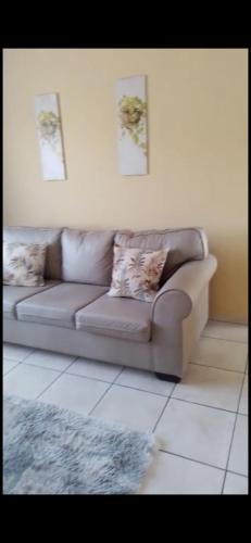 a living room with a couch and a rug at Ross Height Unit 16 in Richards Bay