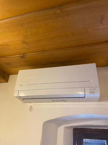 a white stove top oven hanging from a ceiling at Pr Krač Countryside Hideaway in Dol pri Ljubljani