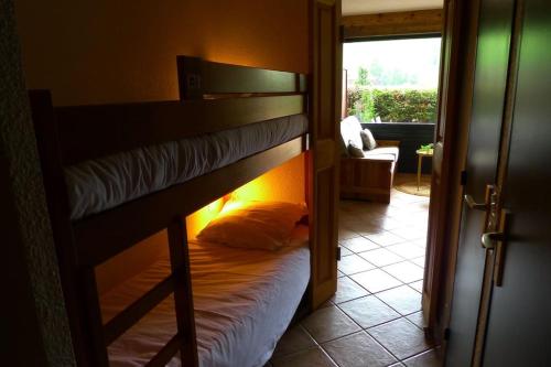 a bunk bed in a room with a open door at Studio 2/4 personnes - Centre village in La Clusaz