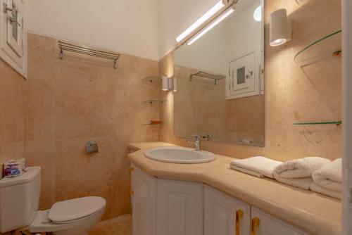 a bathroom with a sink and a toilet and a mirror at Beautiful Cosy 3 bedroom townhouse in South Marina in Hurghada