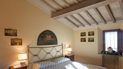 a bedroom with a bed and two lamps and a window at Villa la felce in Cetona