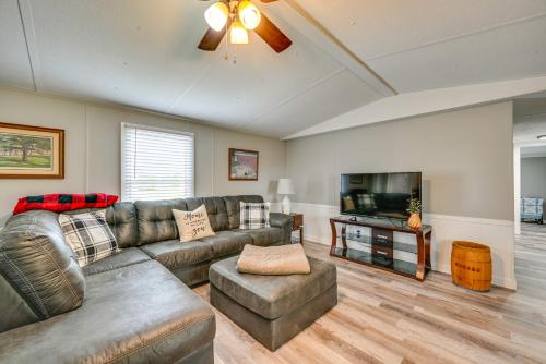 a living room with a couch and a flat screen tv at Kentucky Vacation Rental Half-Mi to Mammoth Cave! in Sloans Crossing