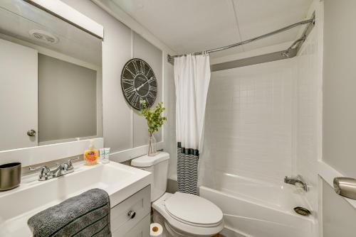 a bathroom with a sink toilet and a clock on the wall at Kentucky Vacation Rental Half-Mi to Mammoth Cave! in Sloans Crossing