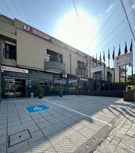 a large building with flags in front of it at Residencial Dona Teresa in Maia