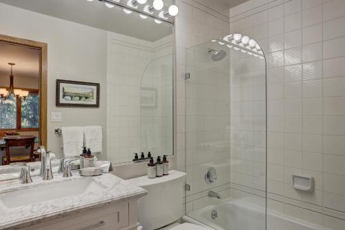a white bathroom with a sink and a shower at Townsend Place in Beaver Creek