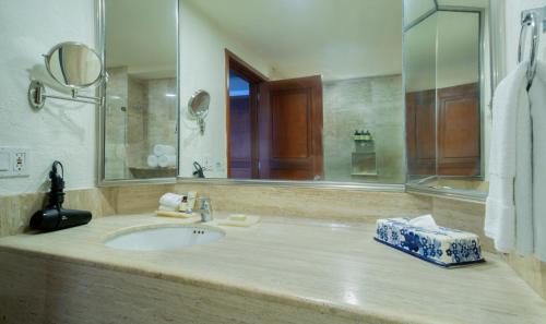 a bathroom with a sink and a large mirror at Fiesta Americana Puerto Vallarta All Inclusive & Spa in Puerto Vallarta