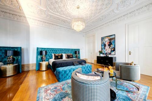 a bedroom with a bed and a couch and a table at 1877 Estrela Palace in Aveiro