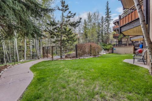 a yard with a bench and a fence at Laurelwood Condominiums 303 in Snowmass Village