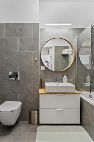 a bathroom with a sink and a mirror at Atria Urban Gateway, 2BR Condo + Pool in Bucharest