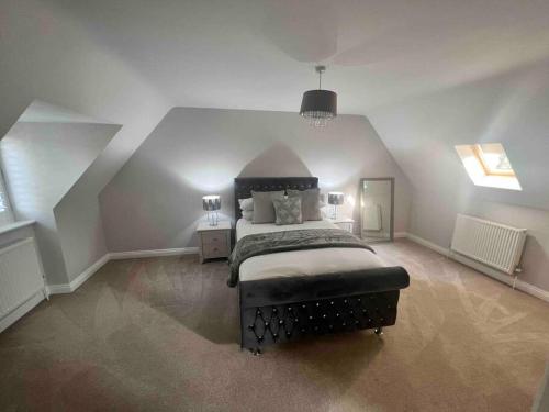 a bedroom with a large bed in a attic at Passing Moon- Filby (Norfolk Broads) in Filby