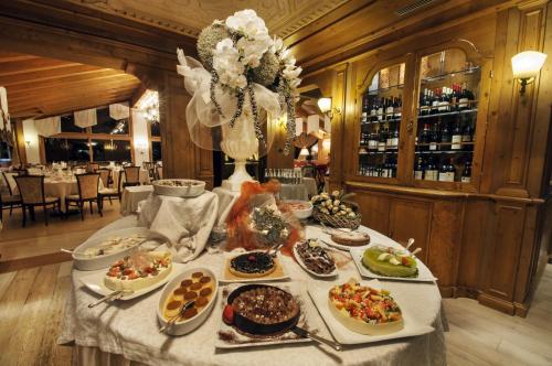 a buffet of food on a table in a restaurant at Cristal Palace Hotel in Madonna di Campiglio