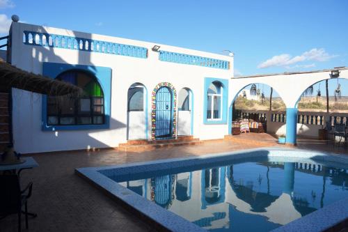 a house with a swimming pool in front of it at The Sunrise Villa in Agadir