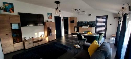 a living room with a couch and a table at AirPortOne in Vecsés