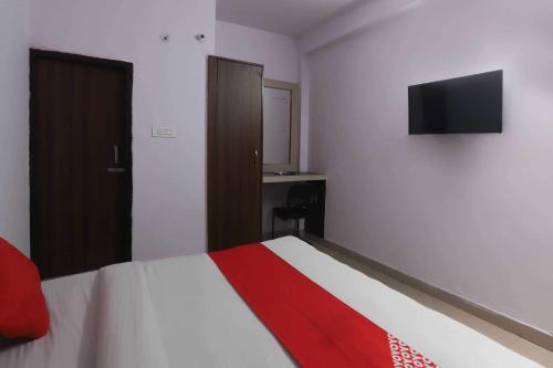 a bedroom with a bed and a television on the wall at Flagship Noida Villa in Indirapuram