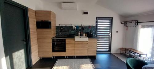 a kitchen with wooden cabinets and a stove top oven at AirPortOne in Vecsés