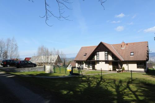 a house with a car parked in front of it at Penzion Alpina Liberec in Liberec