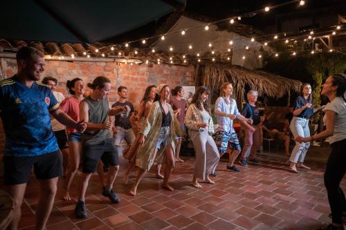 a group of people dancing on a stage at Traveler Hostel in San Gil