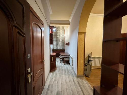 a hallway with a door and a room with a table at One bedroom Apartment in the centre of Yerevan, Amiryan Street 5a in Yerevan