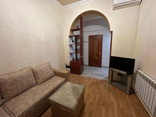 a living room with a couch and a tv at One bedroom Apartment in the centre of Yerevan, Amiryan Street 5a in Yerevan