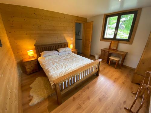 a bedroom with a large bed in a log cabin at Chalet 5 Chambres à Châtel avec Multi Pass Été et 4 Salles de Bain – Confort et Charme Alpins - FR-1-693-1 in Châtel