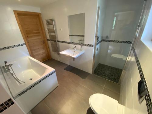 ein Bad mit einer Badewanne, einem Waschbecken und einer Dusche in der Unterkunft Chalet Châtel, 8 pièces, 11 personnes - FR-1-693-1 in Châtel