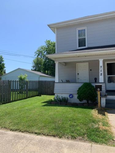 a house with a fence in the yard at Cherry712upstairs in Fairborn