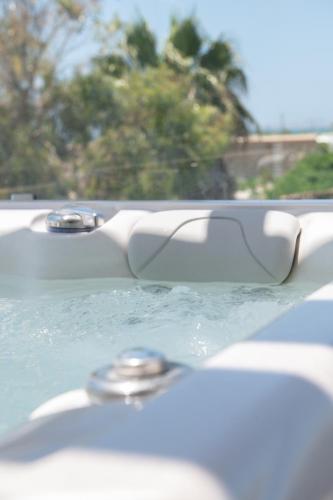 a bathtub filled with water with at Sea Lilies Suites in Plaka