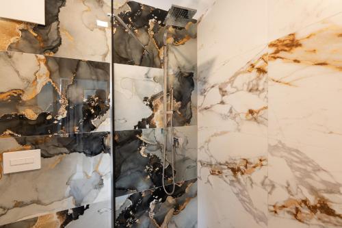 a room with marble walls and a wall covered in art at Hotel & Restaurant Sparta in Oldenburg