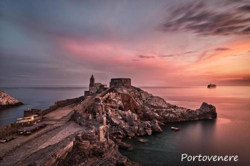 an island in the water with a castle on it at Cinque Terre Bridge in La Spezia