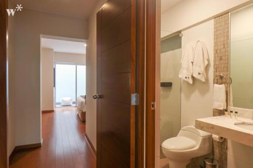 a bathroom with a toilet and a sink at Spectacular 1BR in Miraflores in Lima