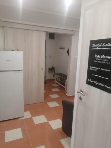 a room with a white refrigerator and a tile floor at RsG Home in Keszthely