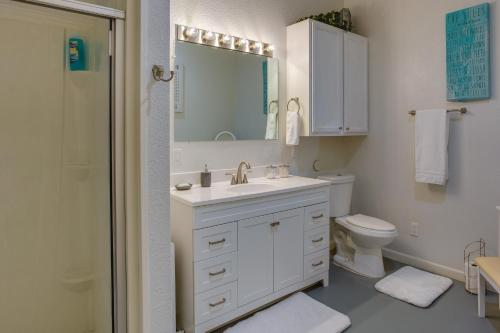 a bathroom with a sink and a toilet and a mirror at Lake Tawakoni Vacation Rental with Dock and Fire Pit! in Wills Point