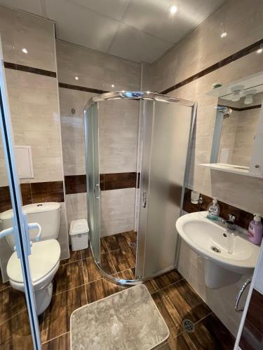 a bathroom with a shower and a toilet and a sink at Admiral Plaza in Sunny Beach