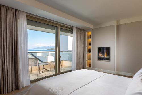 a bedroom with a bed and a view of the ocean at HiddenBay Urla in Urla