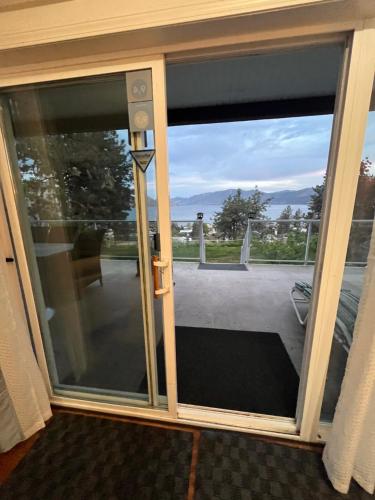 a sliding glass door with a view of a balcony at Heart of Peachland in Peachland
