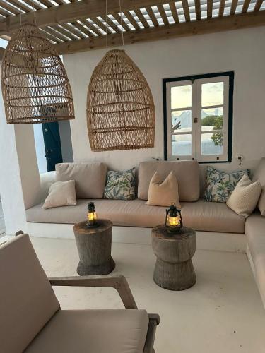 a living room with a couch and two tables at Seagulls Nest in Struisbaai