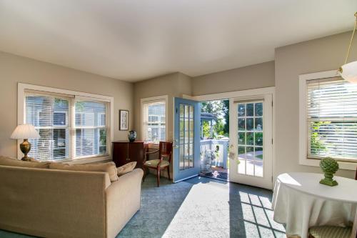 a living room with a couch and windows at Winchester Inn in Ashland